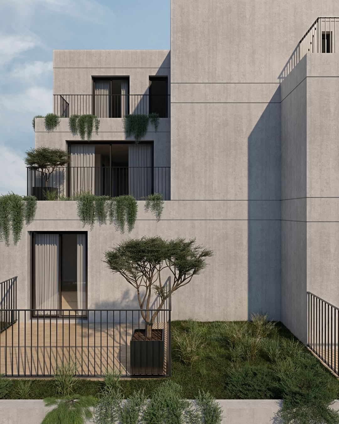 Fachada — arquitetura em betão e vegetação.